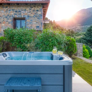 Outdoor hot tub beside the stone villa with mountain views at Villa Mainalis