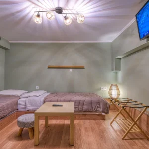 Bedroom 5 with two single beds and warm interior lighting at Villa Mainalis