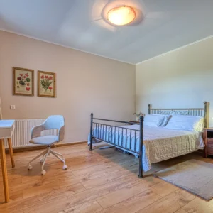 Bedroom 3 with a double bed, desk and seating area at Villa Mainalis