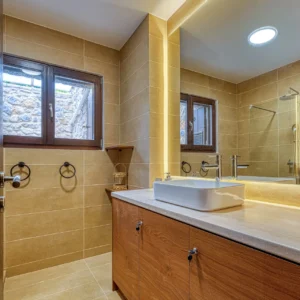 Modern bathroom with walk-in shower and illuminated vanity at Villa Mainalis