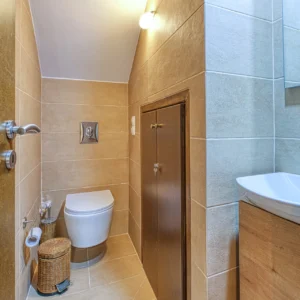 Bathroom with WC, vanity and neutral stone tiling at Villa Mainalis