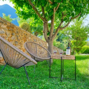 Quiet garden seating beneath a tree at Villa Mainalis