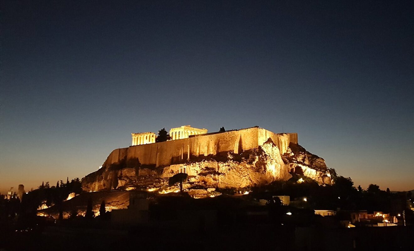 Athens by night — the Acropolis lit above the city